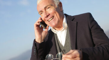 senior executive – mature businessman having a conversation on smartphone in city