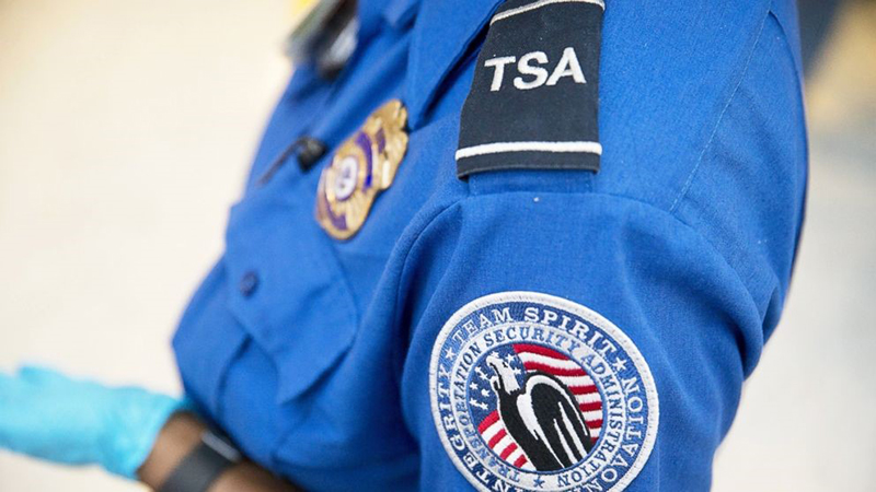 Person wearing blue TSA uniform