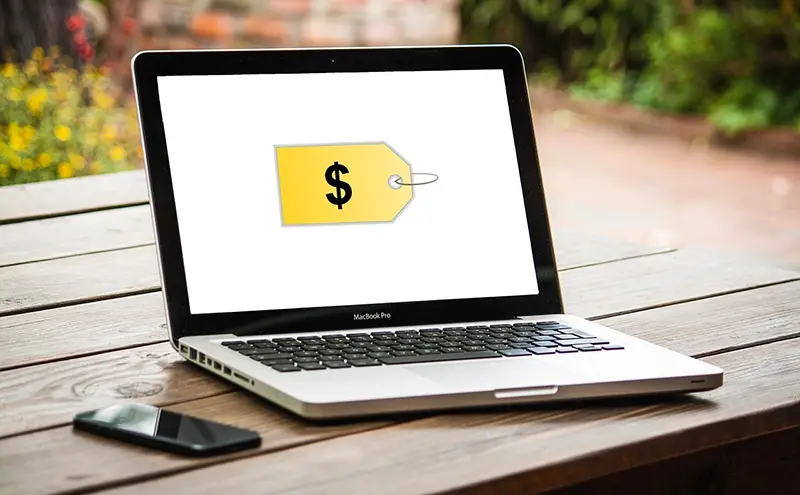 A yellow dollar price tag in the laptop screen