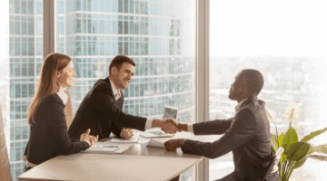 People shaking hands at in an office - enterprise customer support