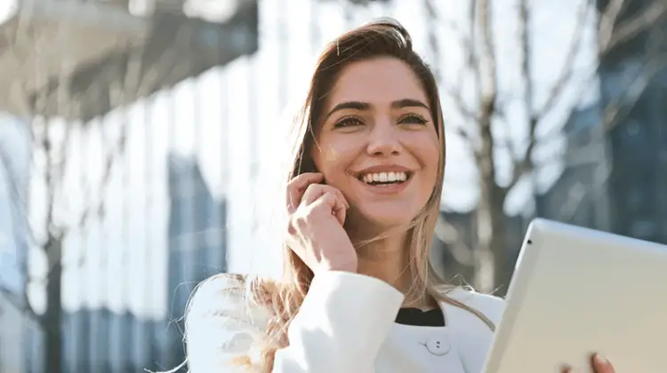 A smiling woman while talking on her mobile phone