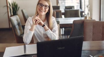smiling woman working on copywriting and content marketing - remote working