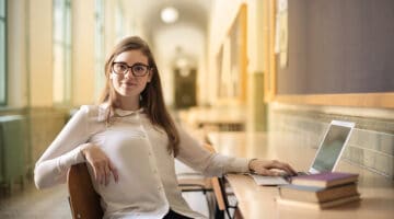 Woman in white long sleeve shirt sitting on chair
