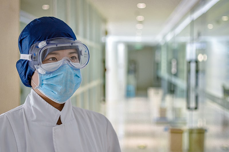 man in white dress shirt wearing blue facemask