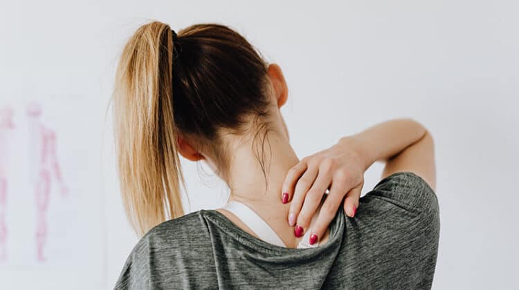 Woman showing pain spot on her back