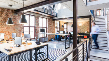 Man walking down the stairs in an open plan office