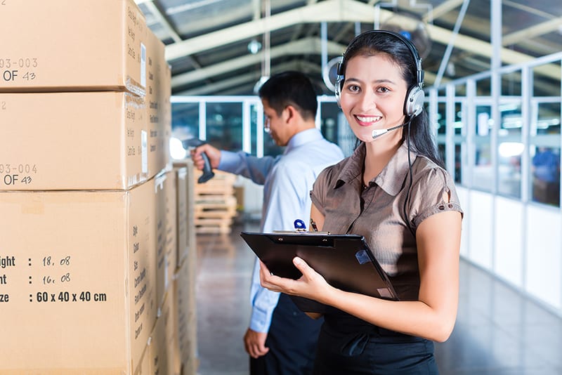 Young asian woman working inside shipping warehouse