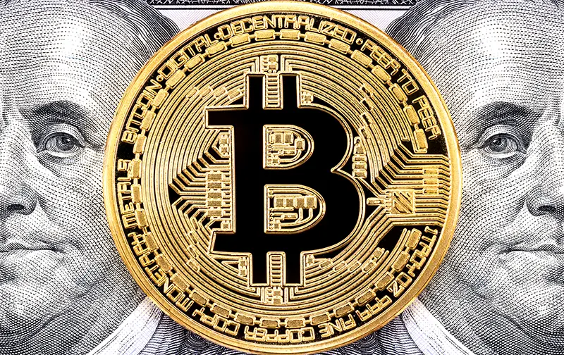Golden bitcoin with Benjamin Franklin portrait from one hundred USD bill. Business concept of worldwide cryptocurrency