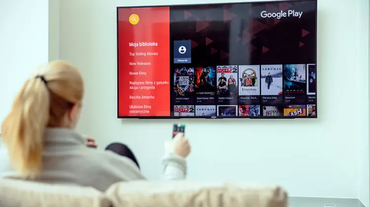 Woman in the couch while watching tv
