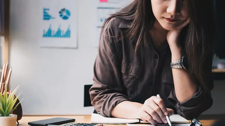 Businesswoman using calculator