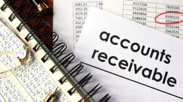 Note pad with figures and paper with account receivable text