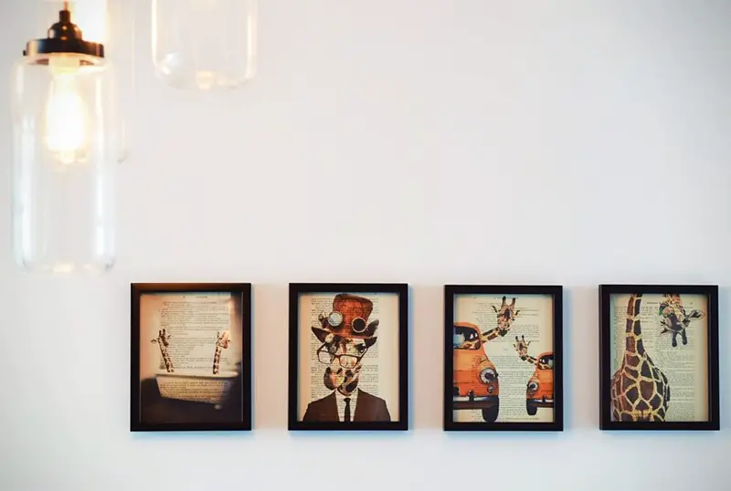 Four square photo frames hang on the wall