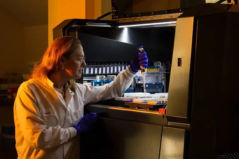 Scientist in white lab coat working in biotech company