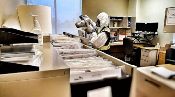 Person cleaning and disinfecting office
