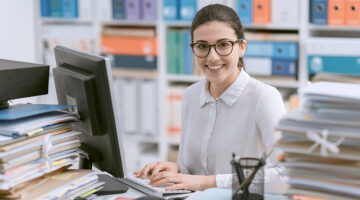 Young happy woman working in an accounting firm