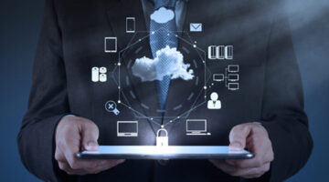 Businessman in black suit hosding black tablet