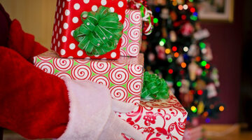 Santa Claus with a pile of Christmas gifts