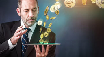 Businessman holding tablet and bitcoin concept