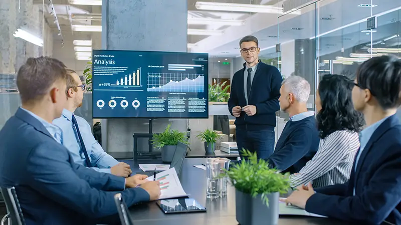 Young stock traders in front of executive managers