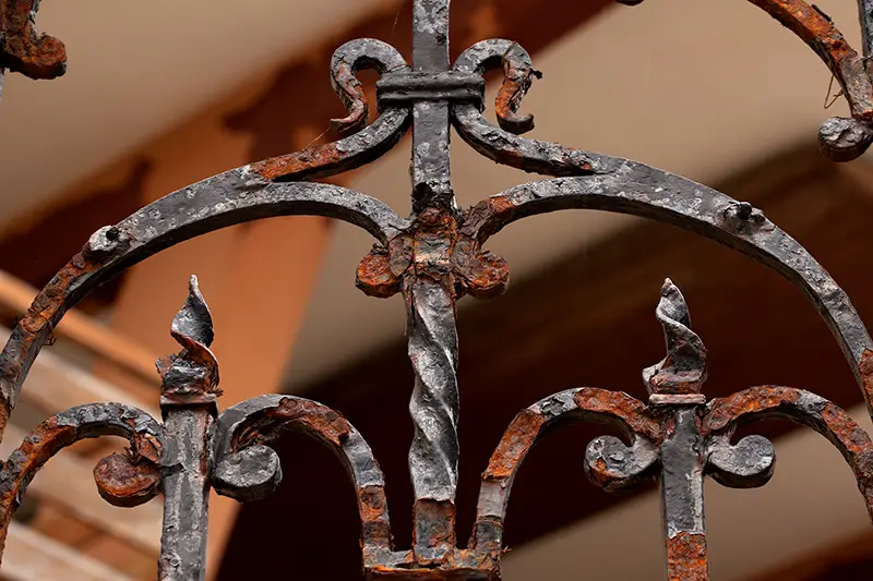 old forged metal gate with corrosion