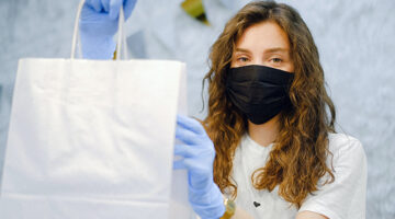 Woman with facemask and latex gloves