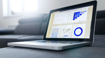 open laptop with statistics and charts