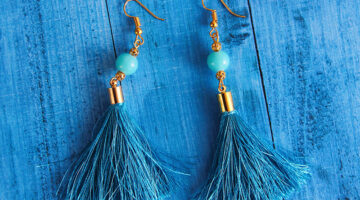 Close up photography of blue earrings