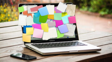 Laptop screen with sticky notes attached