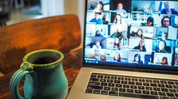 MacBook Pro displaying group of people on conference call
