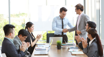 Caucasian businessman showing success business profit graph from white board in meeting