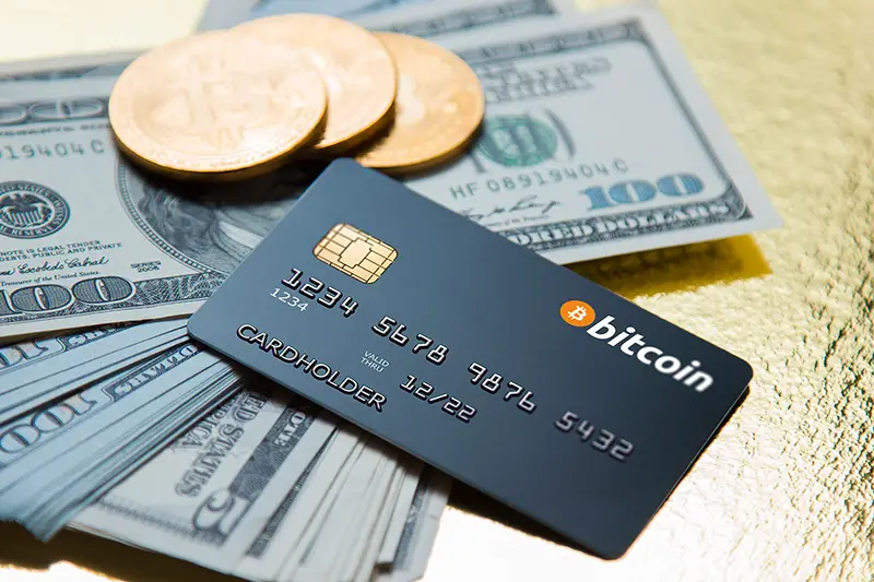 Concept bank card bitcoin on a golden background
