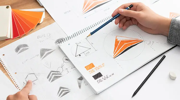 Graphic designer drawing sketches logo design.