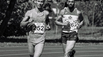 Muscular male athletes running during track and field