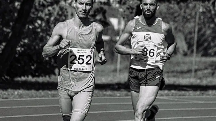 Muscular male athletes running during track and field