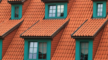 Orange shingles on green house
