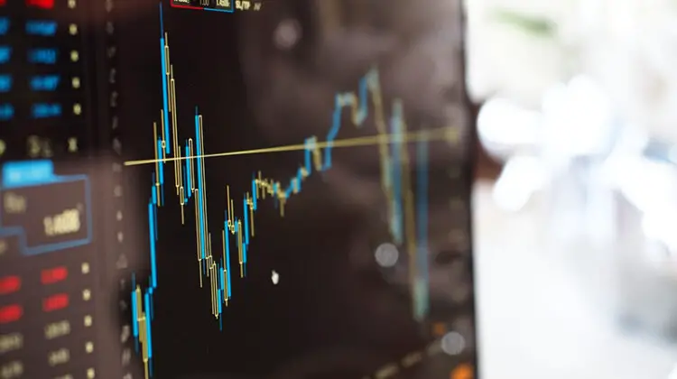Blue and yellow graph on stock market monitor