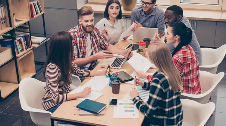businesspeople having relaxed conversation over new project