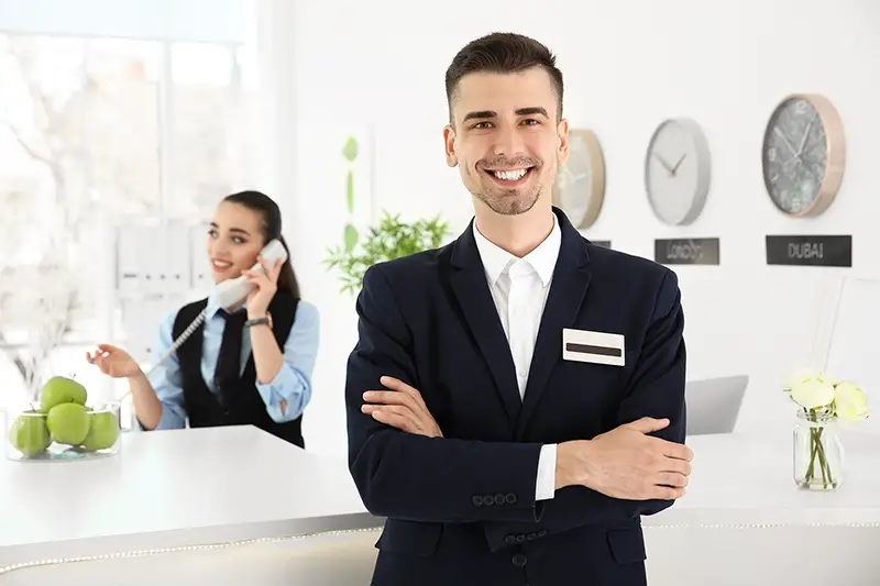 Male receptionist at workplace in hotel