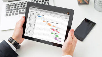 Businessman looking at Gantt chart on tablet computer