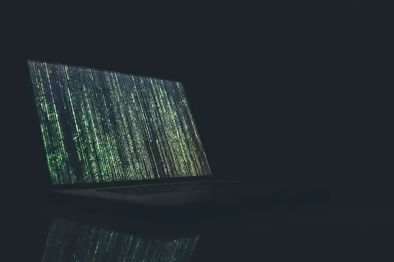 Laptop showing green data on screen