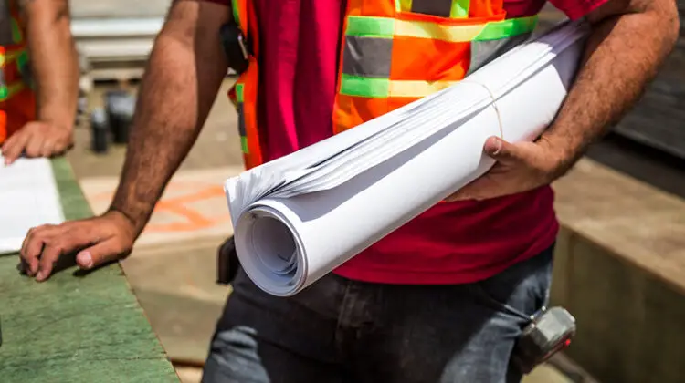 Person holding drafting paper