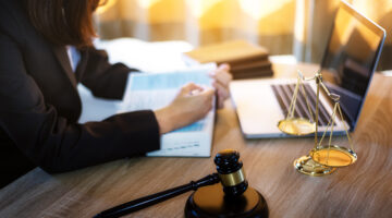 Lawyer business women working and writting in notebook on desk at office