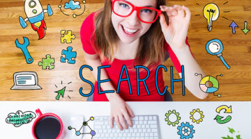 Woman wearing red blouse working in front of her laptop