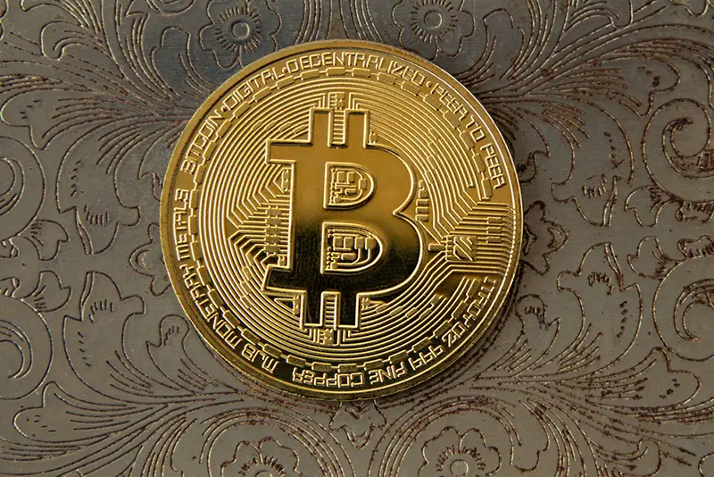 Gold bitcoin with gold background
