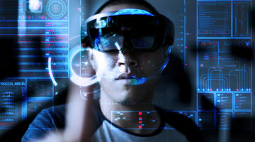 Young men trying Virtual Reality or augmented reality with HoloLens headset - technology