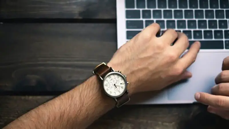 Man wearing brown wrist watch