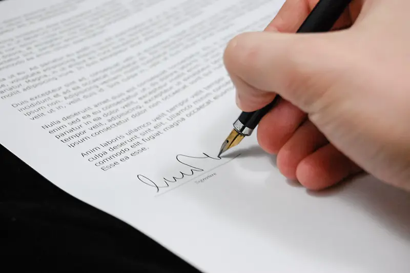 Person signing on documentation paper