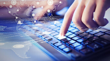 Person using laptop keyboard