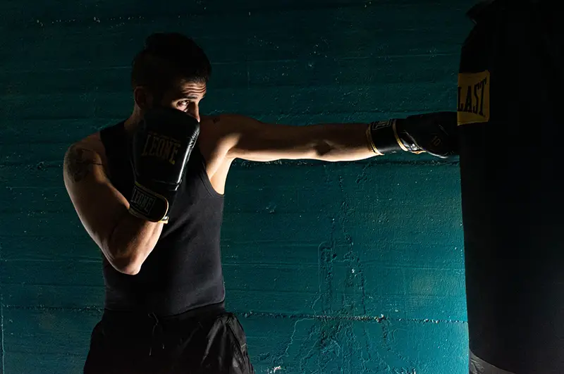 Man wearing black boxing gloves