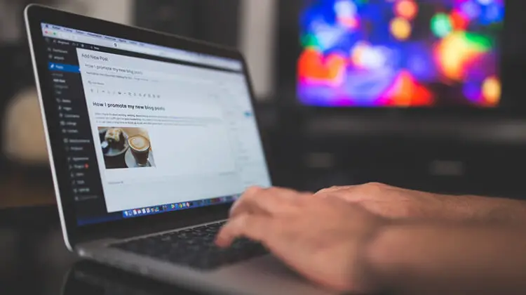 Person typing on silver laptop